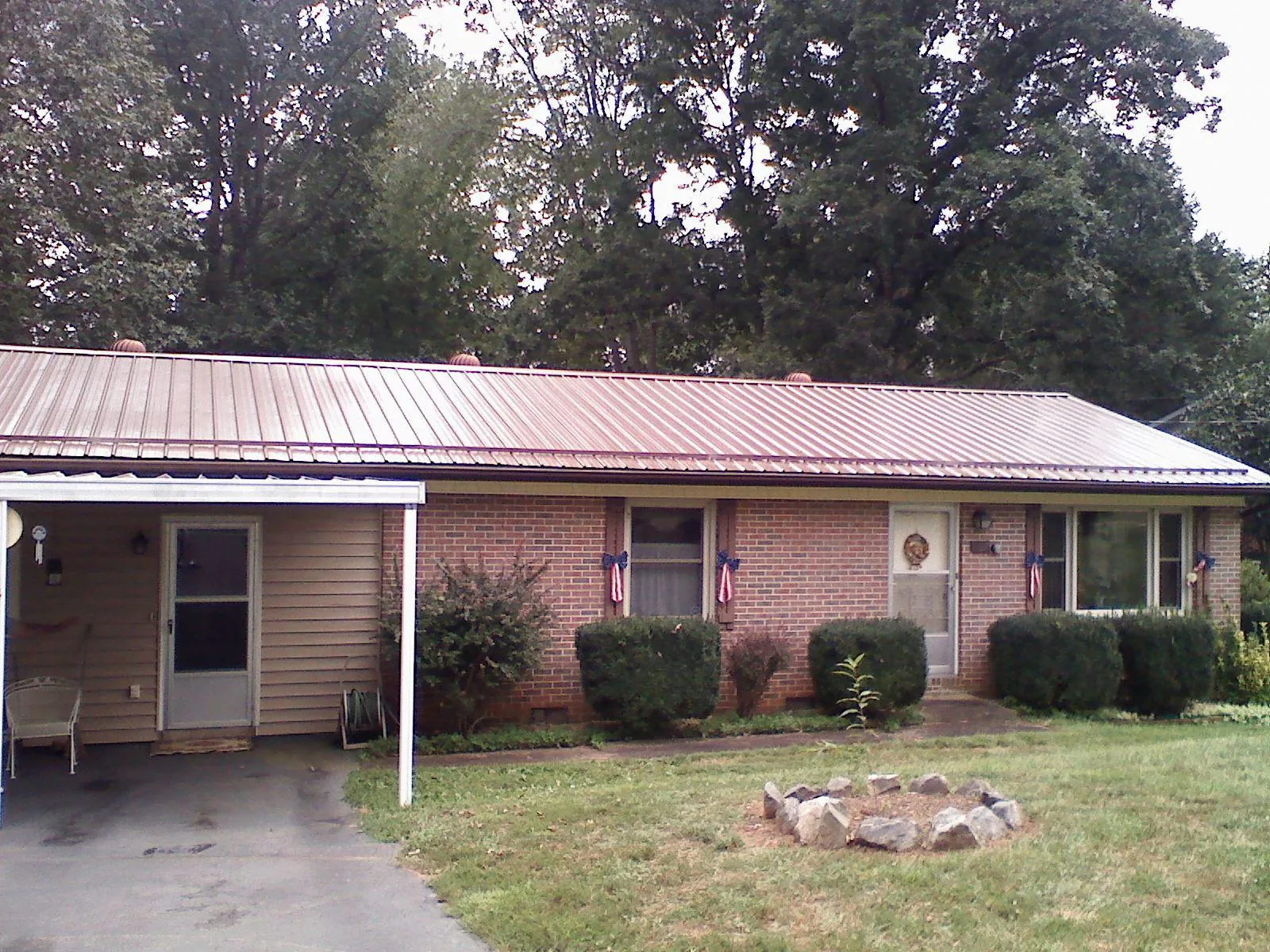 Bronze metal roof and carport on a brick ranch home — Roof Repair work by our crew in Mongaup Valley